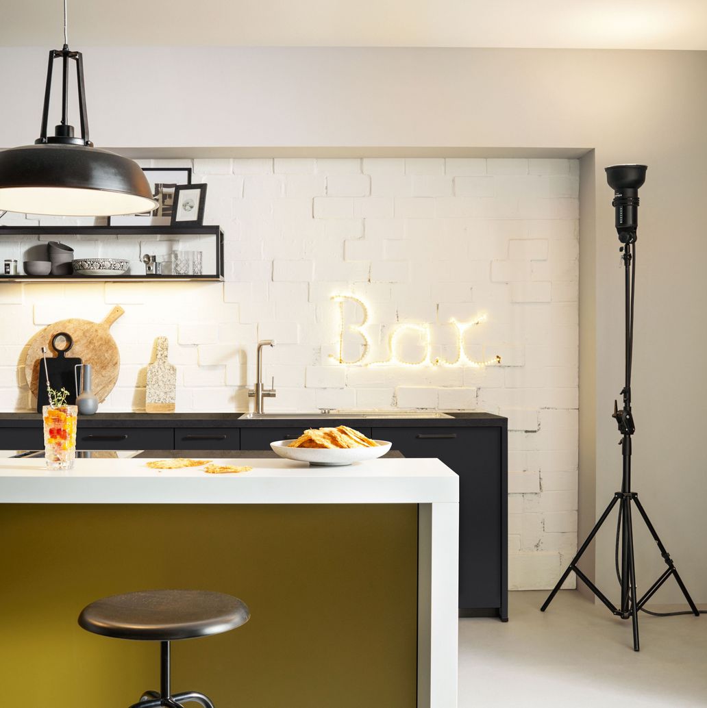 modern black kitchen with olive yellow cooking island